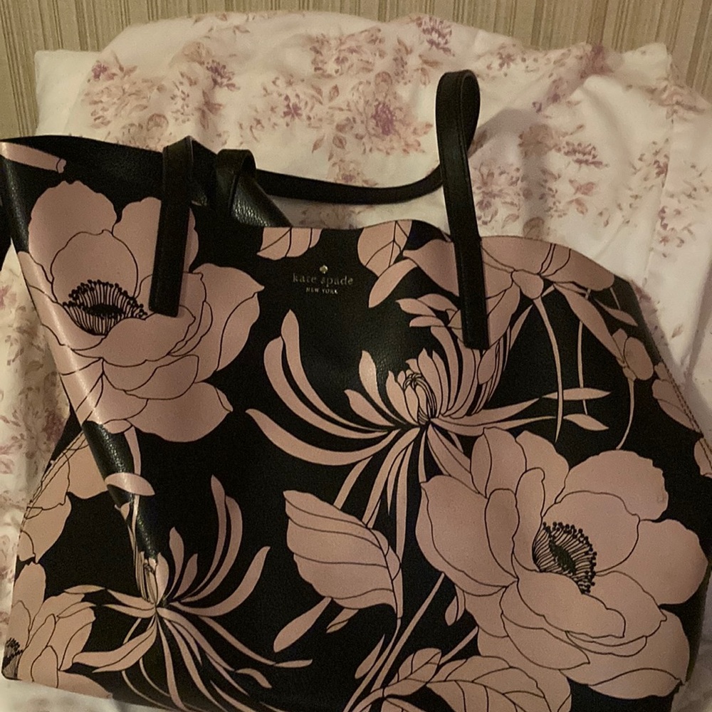 A black and pink, Kate Spade tote bag.